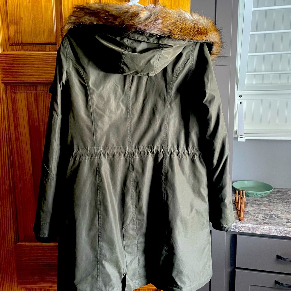 Women’s size medium winter coat. Dark olive green color with fur trim.